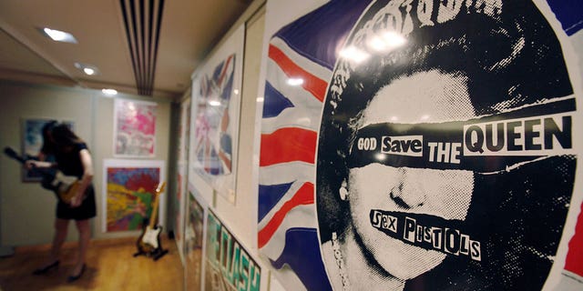 A promotional poster for the 1977 single "God Save the Queen" by the Sex Pistols on display for a rock and pop memorabilia auction, in London, June 25, 2009.