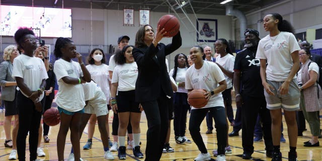 Vice President Harris plays basketball with schoolgirls during a Title IX 50th Anniversary Field Day event at American University. Harris missed a string of shots before finally making her sixth.