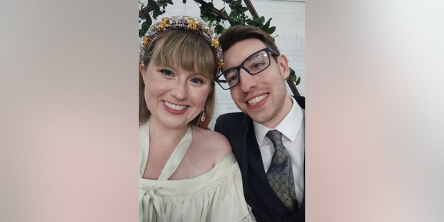 Newlyweds Katie and Kyle Boggemes snap a selfie on their wedding day in Holly, Mich., on June 25, 2022. 
