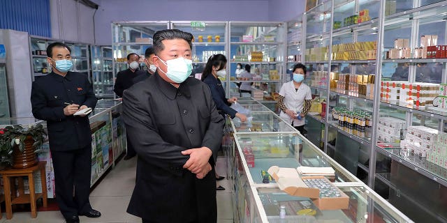 In this photo provided by the North Korean government, North Korean leader Kim Jong Un, center, visits a pharmacy in Pyongyang, North Korea on May 15, 2022.