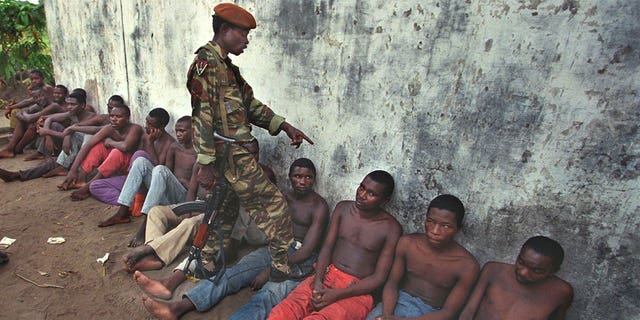 Laurent Kabila's soldiers interrogating prisoners at Mobutu camp in Kinshasa May 19, 1994. Hundreds of ethnic Banyamulenge Tutsis have been arrested in the Congo capital Kinshasa and scores have gone into hiding following a rebellion by army units in the east of the country. (REUTERS/Peter Andrews PA/PN)