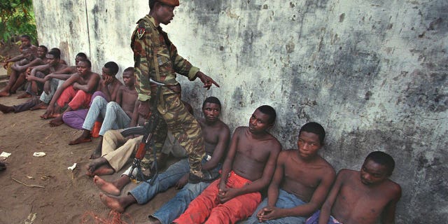 Laurent Kabila's soldiers interrogating prisoners at Mobutu camp in Kinshasa May 19, 1994. Hundreds of ethnic Banyamulenge Tutsis have been arrested in the Congo capital Kinshasa and scores have gone into hiding following a rebellion by army units in the east of the country. (REUTERS/Peter Andrews PA/PN)
