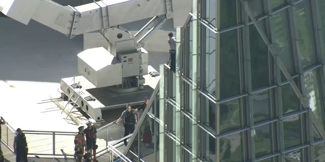 Pro Life Spiderman reaches the top of Devon Tower in Oklahoma City. 