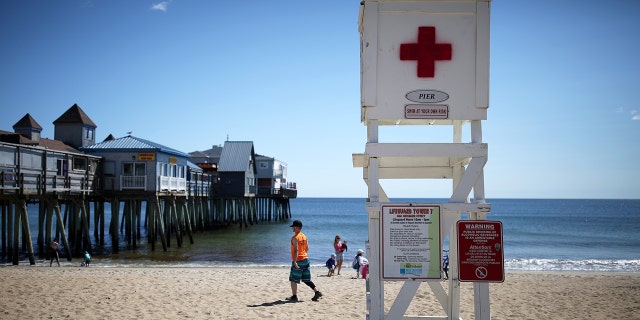 The lifeguard chair is empty and the beach sparsely populated at Old Orchard Beach in Maine on Tuesday, Sept. 7, 2021. (Staff photo by Ben McCanna/Portland Press Herald via Getty Images)