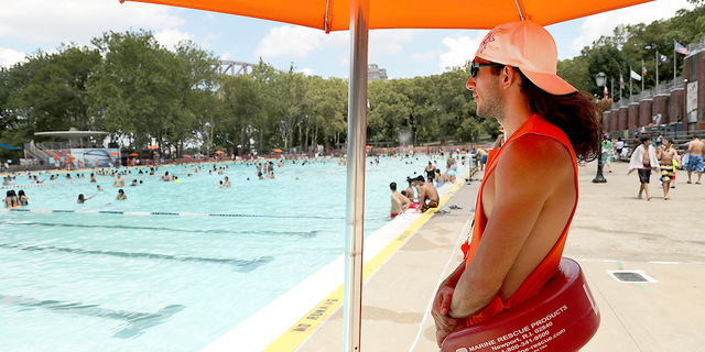 Lifeguard James Dukas watches as people enjoy a hot afternoon at the Astoria Pool in Queens on June 29, 2016, in New York City. (Spencer Platt/Getty Images)