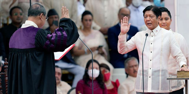 President-elect Ferdinand "Bongbong" Marcos Jr., right, is sworn in by Supreme Court Chief Justice Alexander Gesmundo during the inauguration ceremony at National Museum on Thursday, June 30, 2022 in Manila, Philippines. Marcos was sworn in as the country's 17th president. 