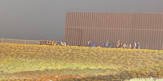 Border Patrol apprehends a group of migrants near a section of the border wall near Hidalgo, Texas.