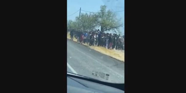 Hundreds of migrants suspected to have entered the country illegally were seen this week wandering the side of a highway in Eagle Pass, Texas.