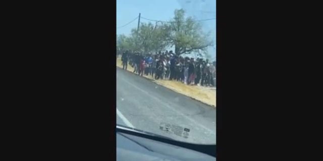 Hundreds of migrants suspected to have entered the country illegally were seen this week wandering the side of a highway in Eagle Pass, Texas. 