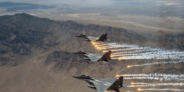 FILE PHOTO: Three U.S. Air Force F-15E Strike Eagles, from Mountain Home Air Force Base, Idaho, fire flares over the Utah Test and Training Range, west of Salt Lake CIty in Utah, U.S., July 3, 2018. 