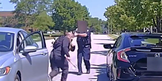 Dash camera footage from the officer's patrol car shows the officer opens fire at the suspect as he runs toward the officer with a hatchet.