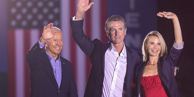 LONG BEACH, CA - SEPTEMBER 13: U.S. President Joe Biden, California Gov. Gavin Newsom and Jennifer Lynn Siebel Newsom wave to the crowd as they campaign to keep the governor in office at Long Beach City College on the eve of the last day of the special election to recall the governor on September 13, 2021 in Long Beach, California. (Photo by David McNew/Getty Images)