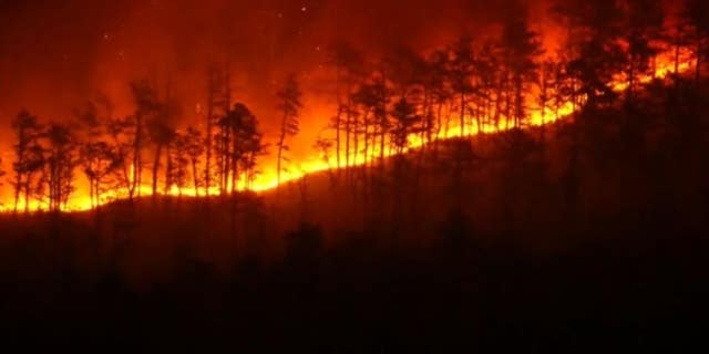 A wildfire burning at Wharton State Forest in New Jersey spread to at least 7,200 acres on Monday morning, state fire officials said.