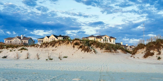 Waterfront beach houses are shown on the Outer Banks of North Carolina.
