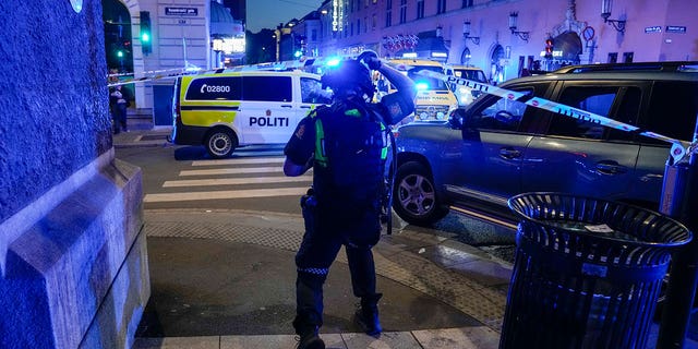 Police gather at the site of a mass shooting in Oslo, in the early hours of Saturday, June 25, 2022.