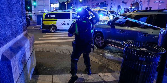 Police gather at the site of a mass shooting in Oslo, early Saturday, June 25, 2022.