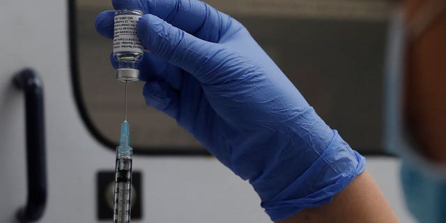 A vial of the phase 3 Novavax coronavirus vaccine is seen ready for use in the trial at St. George's Hospital in London, Oct. 7, 2020.