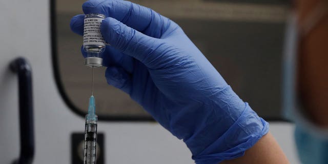 A vial of the phase 3 Novavax coronavirus vaccine is seen ready for use in the trial at St. George's Hospital in London, Oct. 7, 2020.