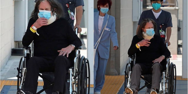 Ozzy Osbourne pictured leaving the hospital with wife Sharon Osbourne on Wednesday following a