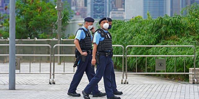 Police officers patrol outside a Hong Kong high-speed train station for the visit by President Xi Jinping to mark the 25th anniversary of the city's handover to China, Thursday, June 30, 2022.