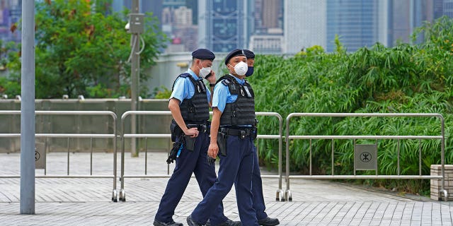 Police officers patrol outside a Hong Kong high-speed train station for President Xi Jinping's visit to mark the 25th anniversary of the city's handover to China on Thursday 30 June 2022.