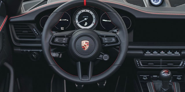 The interior features red and white stitching.