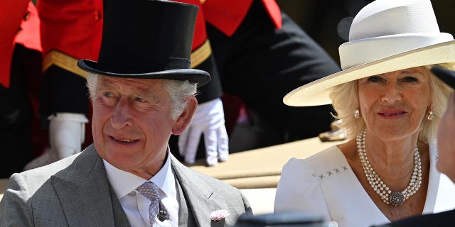 Prince Charles, Prince of Wales (left) and Britain's Camilla, Duchess of Cornwall arrive in a horse-drawn carriage as they arrive for the second day of the Royal Ascot Racecourse, in Ascot, west London on June 15, 2022.