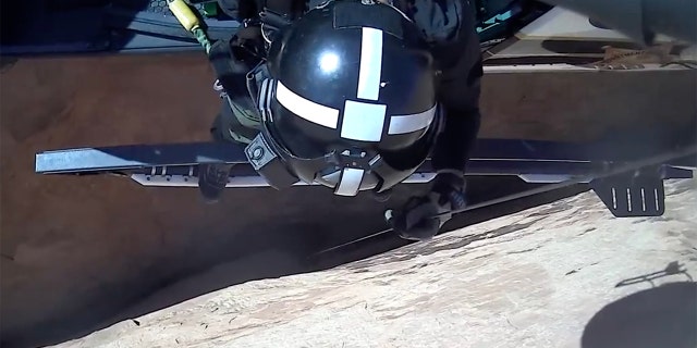 An image taken from the dramatic video of a rescue pulled off by a highly skilled helicopter crew in Utah on Friday.
