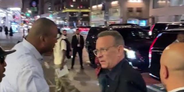 Security guards helped Tom Hanks find his way to his vehicle after an encounter with fans.
