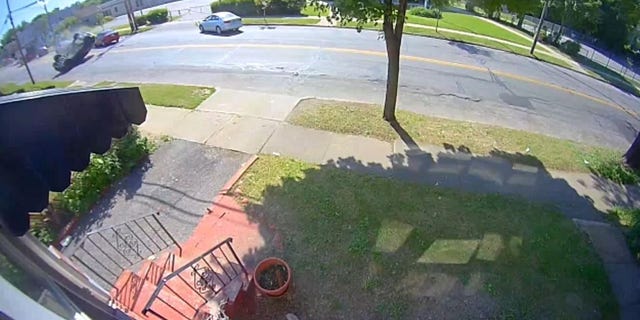 The video shows the black jeep turning fast on the street when it hits a pedestrian vehicle, causing it to get out of control and overturn.