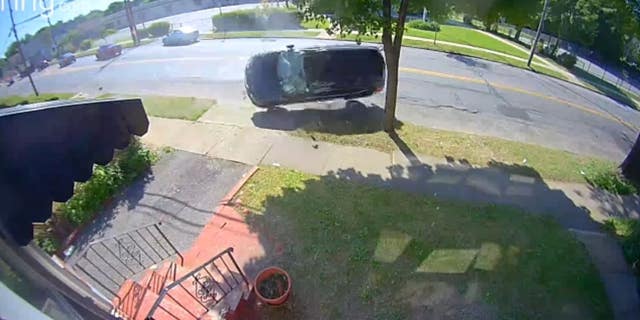 The vehicle is rolling down the street before crashing into a tree and stopping, the video appears to show. 