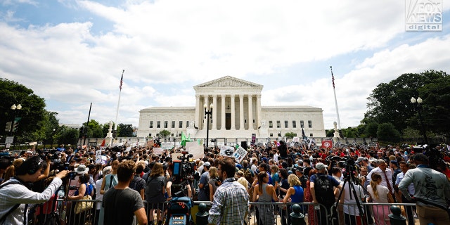 Hundreds of people gather outside the Supreme Court awaiting the Dobbs ruling.