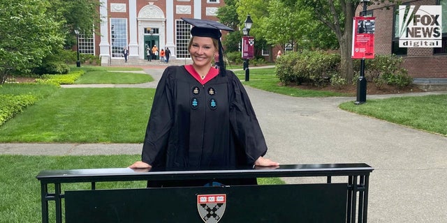 Shelane Etchison in her graduation robes after completing two master's programs at Harvard University.