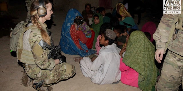 Shelane Etchison gathers information about the Taliban from women and children in the Helmand Province.