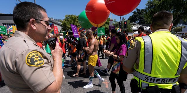 Sheriff's deputies keep an eye on the LA Pride Parade as it passes by in West Hollywood, California.