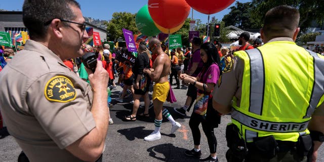 Sheriff's deputies keep an eye on the LA Pride Parade as it passes by in West Hollywood, California.