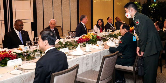 China's Minister of Defense General Wei Fenghe, center right, speaks with US Secretary of Defense Lloyd Austin, left, during the 19th Shangri-La Dialogue of the International Institute for Studies (IISS), Asia's premier defense forum, in Singapore, Saturday, June 11, 2022. 
