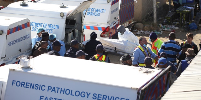 A body is removed from a nightclub in East London, South Africa, Sunday, June 26, 2022. South African police are investigating the deaths of at least 20 people at a nightclub in the coastal town of East London early Sunday morning. It is unclear what led to the deaths of the young people, who were reportedly attending a party to celebrate the end of winter school exams. (AP Photo)
