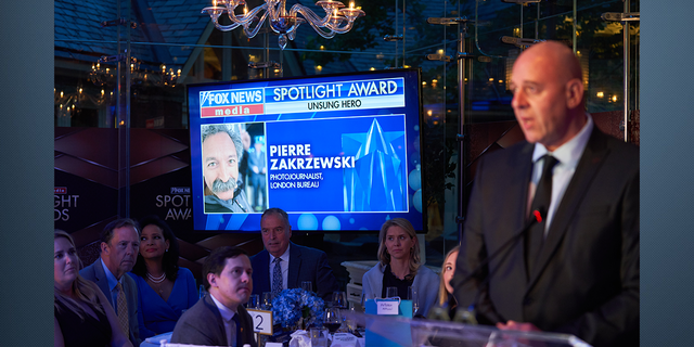 FOX News London Bureau Chief Dragan Petrovic accepting the Unsung Hero award on behalf of Pierre Zakrzewski.
