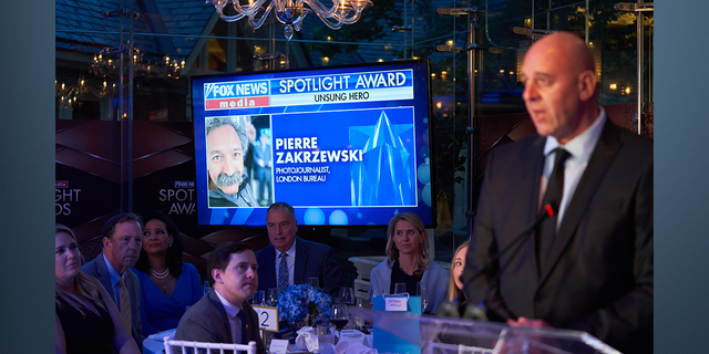 FOX News London Bureau Chief Dragan Petrovic accepting the Unsung Hero award on behalf of Pierre Zakrzewski.