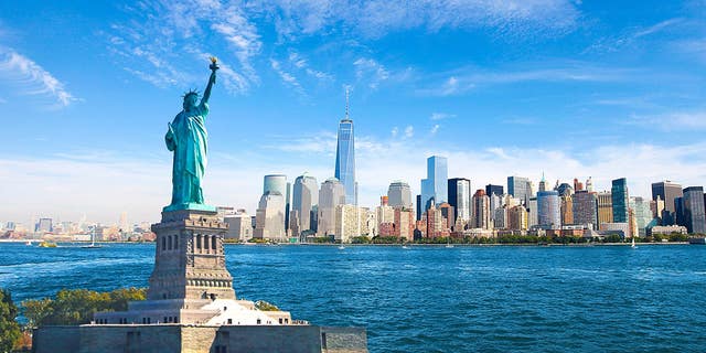 The Statue of Liberty overlooking Lower Manhattan on New York City's Hudson River.