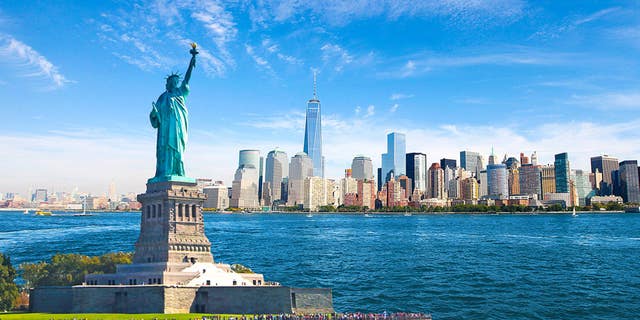 The Statue of Liberty overlooking lowering Manhattan on New York City's Hudson River.