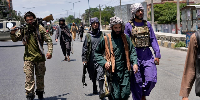 Taliban fighters guard at the site of an explosion in Kabul, Afghanistan, Saturday, June 18, 2022. Several explosions and gunfire ripped through a Sikh temple in Afghanistan's capital. 
