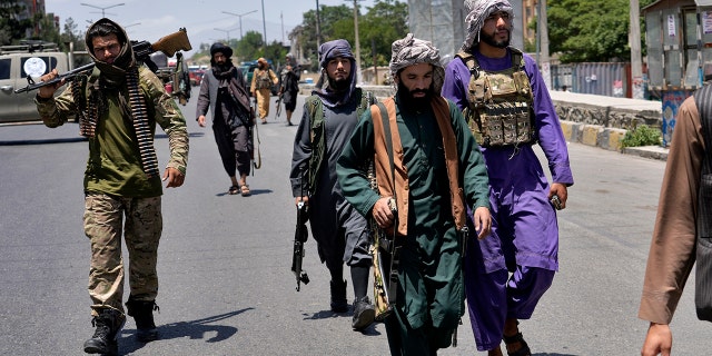 Taliban fighters guard at the site of an explosion in Kabul, Afghanistan, Saturday, June 18, 2022. Several explosions and gunfire ripped through a Sikh temple in Afghanistan's capital. 