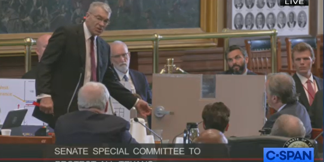 안부. 스티브 맥크로, 텍사스 공공안전국 국장, shows Robb Elementary classroom door during state Senate special hearing on Uvalde school shooting.