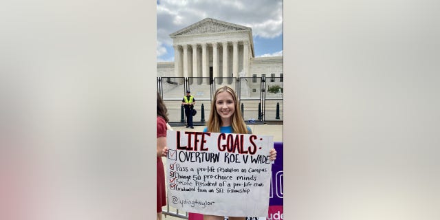 A girl holds a pro-life sign in front of the Supreme Court after the historic ruling overturning Roe vs. Wade.
