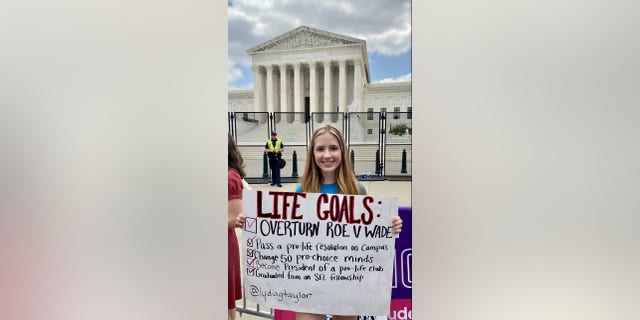 A girl holds a pro-life sign in front of the Supreme Court after the historic ruling overturning Roe vs. Wade. 