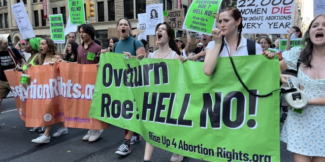 Protesters hold a sign protesting Roe vs. Wade being overturned in New York City.