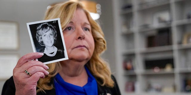 Nassau County District Attorney Anne Donnelly holds a photo of Diane Cusick during an interview with The , Wednesday, June 22, 2022, in Mineola, N.Y.