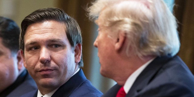 Florida Gov. Ron DeSantis, left, and then-President Donald Trump